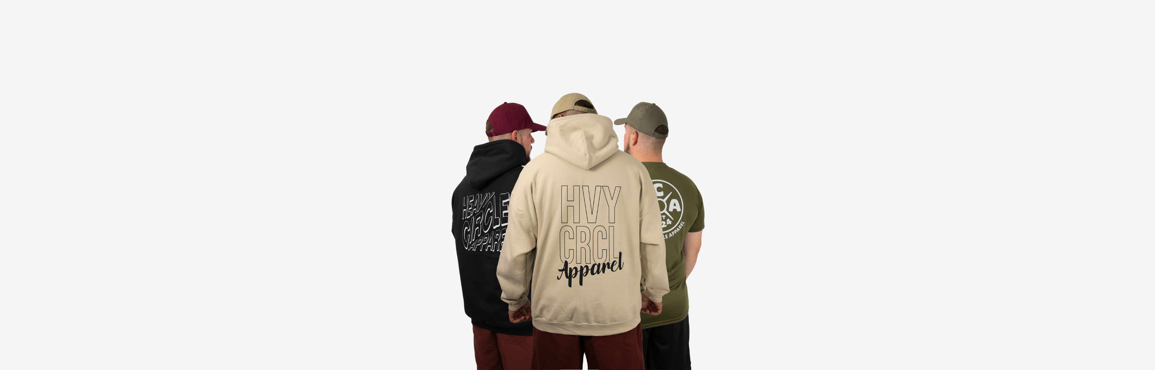 A flay lay of a black sweater featuring a large front print that says 'HVYCRCL Apparel'